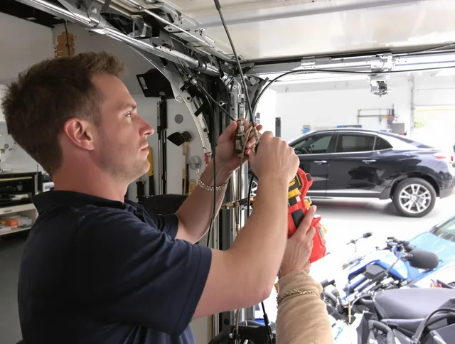 Valley Falls Garage Door Repair safety certified technician performing cable replacement in Valley Falls
